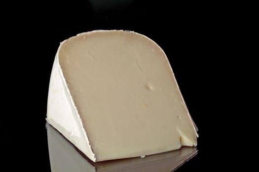 Dutch goat cheese on a black background