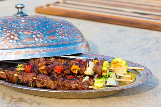 Seasoned beef and vegetable  skewers served with Turkish style copper plate.