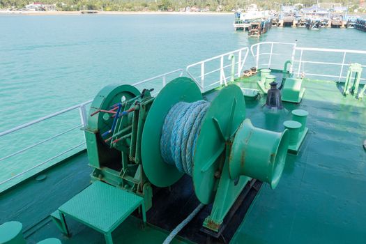 Winch with rope on ferry dropping anchor forward mooring station