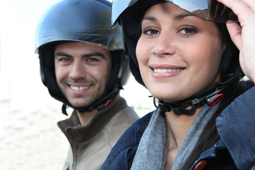 Couple wearing motorbike helmets