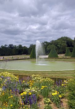 formal garden, flowers and fountain, water jet   France