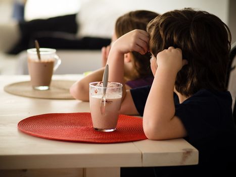 Children having a hot chocolate at the table