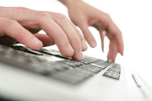 Detail of businessman hands typing on computer keyboard. Over white background.