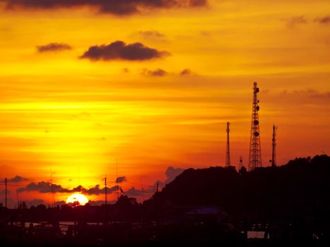 Golden sky with telecommunication tower on top of mountain