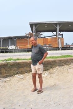 African American male standing on the beach.