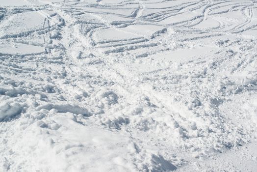 Ski tracks in fresh powder snow - skiing background