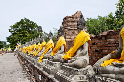 row of buddha image in wat yai chai mongkol, ayutthaya, thailand