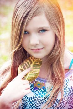 Portrait of a blode girl outdoors in the park 