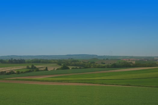 a green country and a blue sky