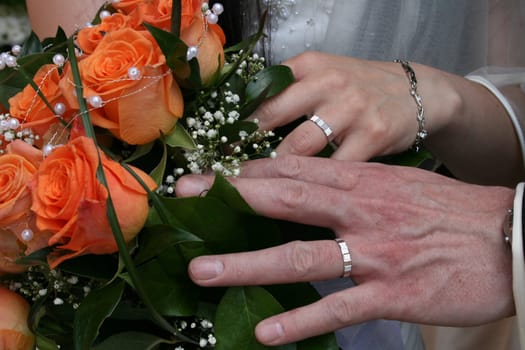 nice orange roses from the wedding and hands 