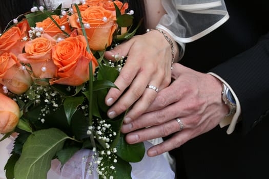 nice orange roses from the wedding and hands 