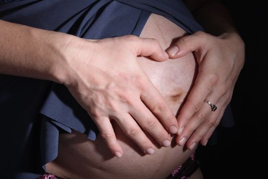 detail of young mother on the black background