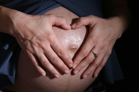 detail of young mother  on the black background