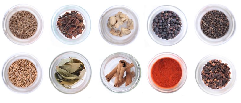 different spices in the glass on the white background