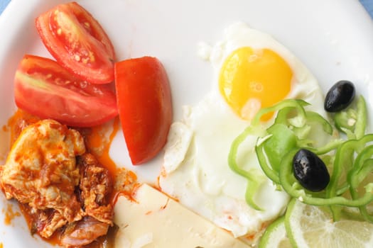gourmet food with egg tomato and olives