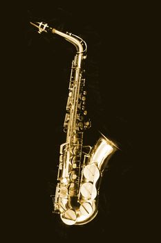 very old saxophone on the black background