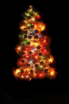 color xmas tree isolated on the black background
