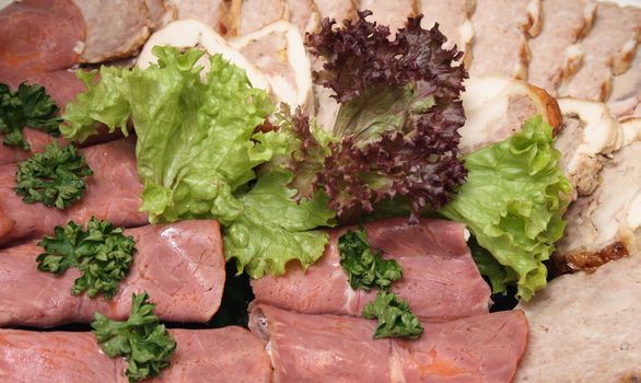 salami background with green leaves from the party 