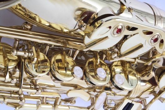 very old saxophone on the white background