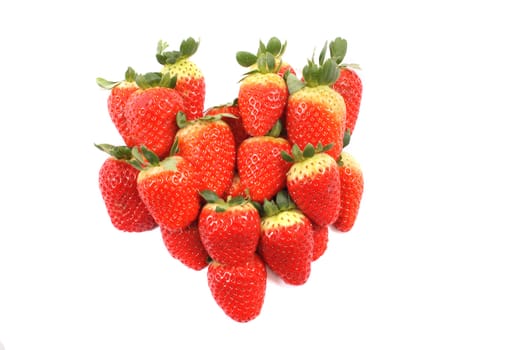 heart from the red strawberries on the white background 