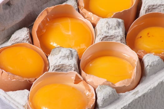 raw yellow eggs in the paper box 