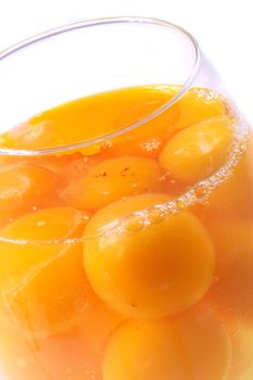 raw yellow eggs on the white background 