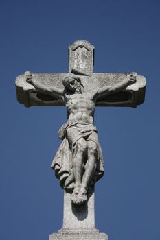crucifix and blue sky from the burial place