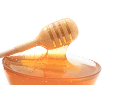 glass with honey isolated on the white background