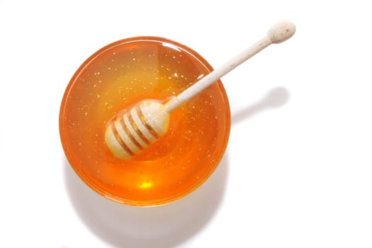 sweet honey and wooden stick on the white background