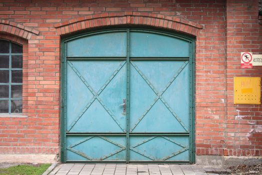 green door for car in the red wall