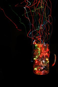empty christmas glass cup with color lights in the dark night