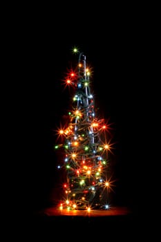 christmas alcohol bottle with color lights on black background