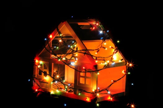 christmas house with color lights in the dark night