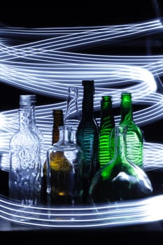 empty bottles in the night with lights curves
