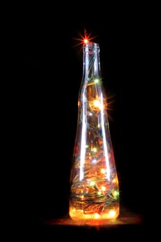 christmas bottle with color lights in the dark night