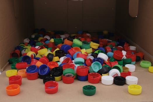 color plastic caps in the empty paper box