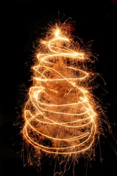 christmas tree from the sparklers in the dark night