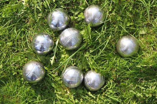 petanque bowls in the green grass as sport background