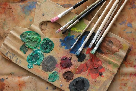 paint brushes and color on the palette background