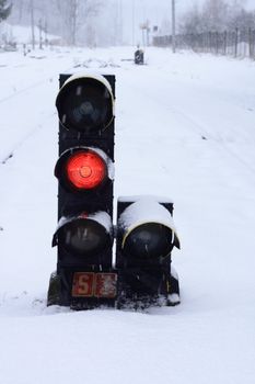 small train stoplight  in the snowy wheather