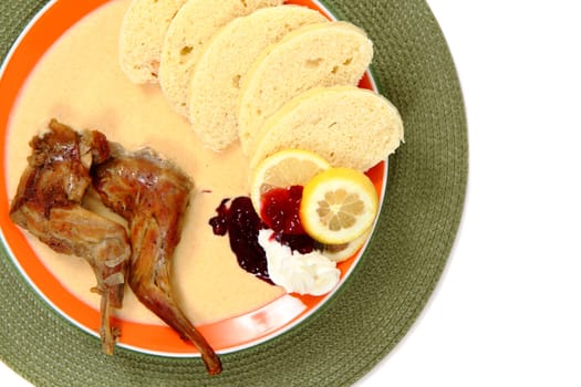 carrot sauce with rabbit legs on white background