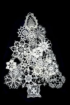 christmas tree from the snowflakes isolated on the black background