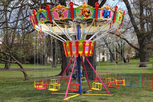 empty old carousel in the green garden 