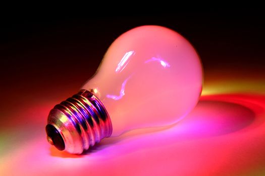 color light bulb in the dark night 