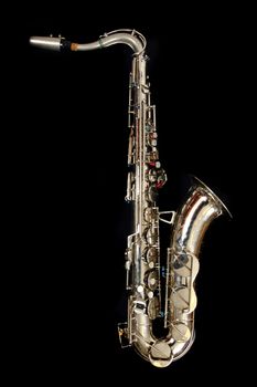 old saxophone isolated on the black background