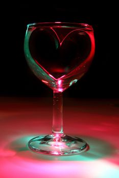 valentine heart in the glass of water in the dark night