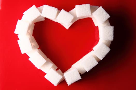 valentine heart from the sugar on the red background