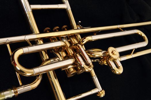 old golden trumpet detail isolated on the black background