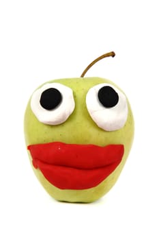 green apple with plasticine smile isolated on the white background