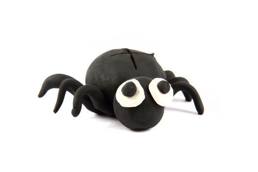 black spider from the plasticine isolated on the white background